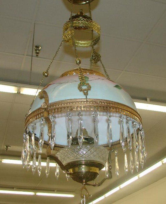 Victorian Hanging Hanging Oil Lamp with Prisms: Victorian Hanging Hanging Oil Lamp with Hanging Prisms, Gilt Construction & Hand Painted Shade. Has been Converted to Electricity. Auction Estimate $200-300.