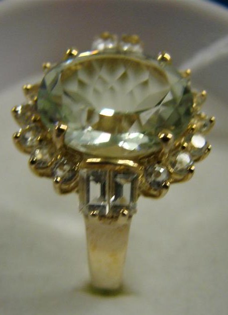 10K Yellow Gold Ring with a Light Blue Topaz & Sur: 10K Yellow Gold Ring with a Light Blue Topaz & Surrounding White Sapphires. Size 8. 4 Grams. Auction Estimate: $150-300.