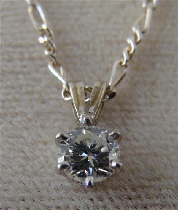 Solid 14K White Gold Diamond Solitaire Pendant.: Solid 14K White Gold Diamond Solitaire Pendant. The Stunning, Brilliant Cut Diamond is clean. Comes with an 18" Sterling Silver Chain. Auction Estimate: $150-300.