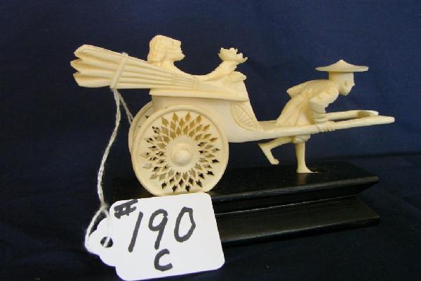 Carved Ivory Figure: Man w/ Rickshaw: Carved Ivory Figure Depicting a Man Pulling a Rickshaw with Lady Passenger. 5" Length. Auction Estimate $200-300. ALL IVORY IN THIS AUCTION IS "PRE-BAN", HOWEVER, IT IS ILLEGAL TO SHIP IVORY OUTSIDE T