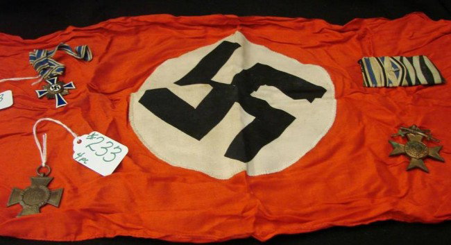 4 pc. German WWI & II Memorabilia. Includes an Iro: 4 pc. German WWI & II Memorabilia. Includes an Iron Cross, Mother's Cross, and one other Medal, along with a WWII Small Company German Flag. Auction Estimate: $300-500.