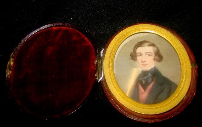 19th c Portrait Painting on Ivory of English Gent: 19th c Portrait Painting on Ivory of English Gent wearing Black Coat, Red Shirt, and Black Ascot with Stick Pin. Mounted in Velvet Lined Oval Leather Case. NOTE: Case hinge no longer working. Auction