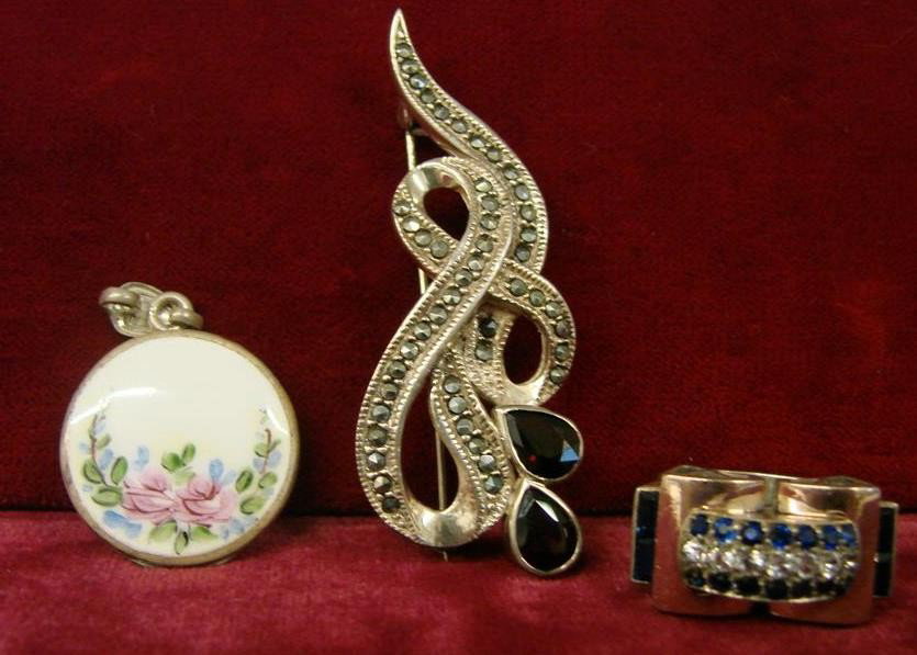 3pcs of Sterling Silver Estate Jewelry : 3 Sterling Silver Pieces of Jewelry, Includes a Music Note Brooch With Marcasite & Garnet, a Locket & a Blue Stone Ring in a Unique Setting. 24.9 Grams. Auction Estimate $50-100.