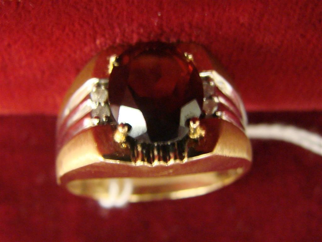 10K Yellow & White Gold Garnet & Diamond Ring Sz10: 10K Yellow & White Gold Garnet & Diamond Ring, with a Large Oval Garnet, Size 10; 5.5 Grams. Auction Estimate $200-300.