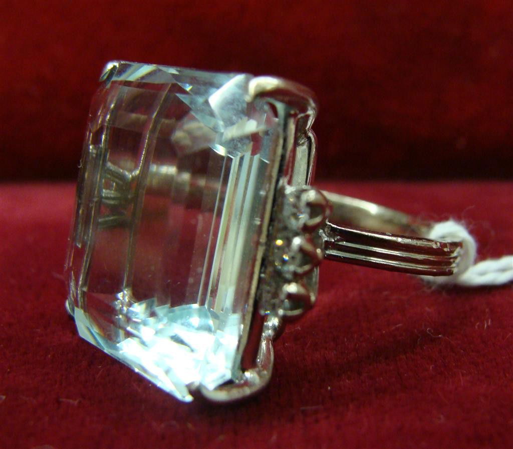 Art Deco 18K White Gold Aquamarine & Diamond Ring.: Art Deco 18K White Gold Aquamarine & Diamond Ring. Guaranteed Genuine Emerald Cut Aquamarine stone with Diamond Accents. Size 6.5; 9.6 Grams. Auction Estimate $400-600.