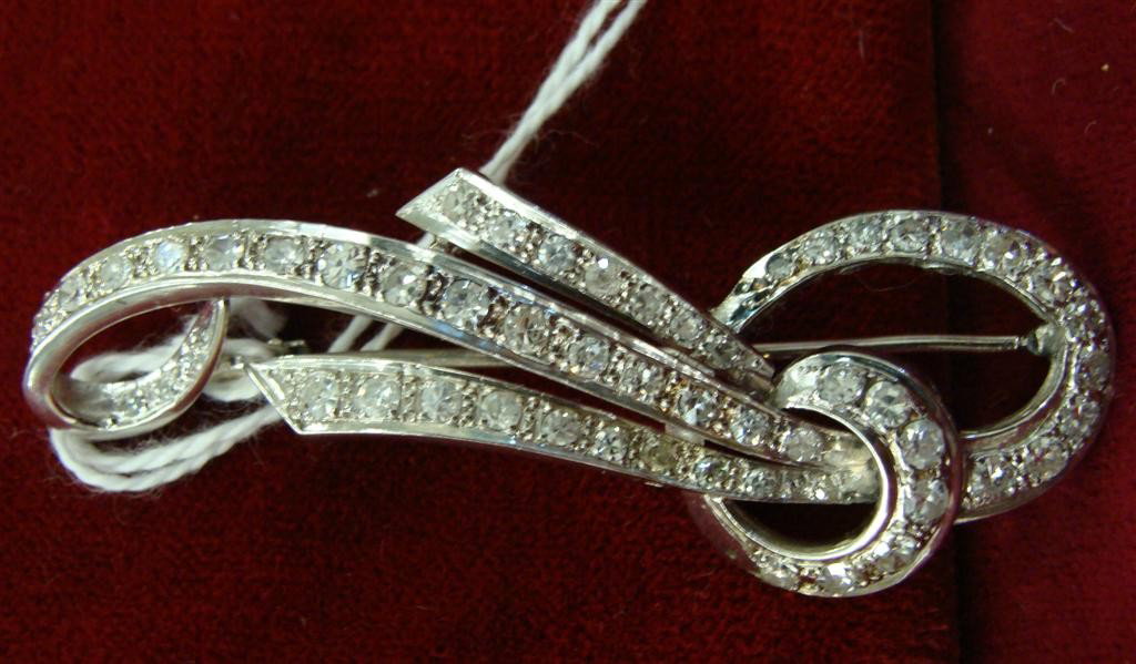 Antique Art Deco Platinum Diamond Brooch 2.75ct tw: Antique Platinum Diamond Brooch with Approximately 2.75 carats tw Diamonds forming Geometric Swirls. 8.4 Grams. Auction Estimate: $1000-1500.
