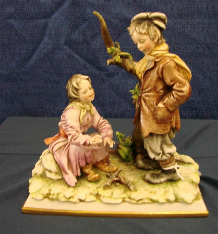 19th c Capodimonte Figurine Girl & Boy at Campfire: 19th Century Capodimonte Figurine Depicting Young Girl and Boy at Camp Fire. The Girl is seated and the Lad stands beside her. Auction Estimate $100- 200.