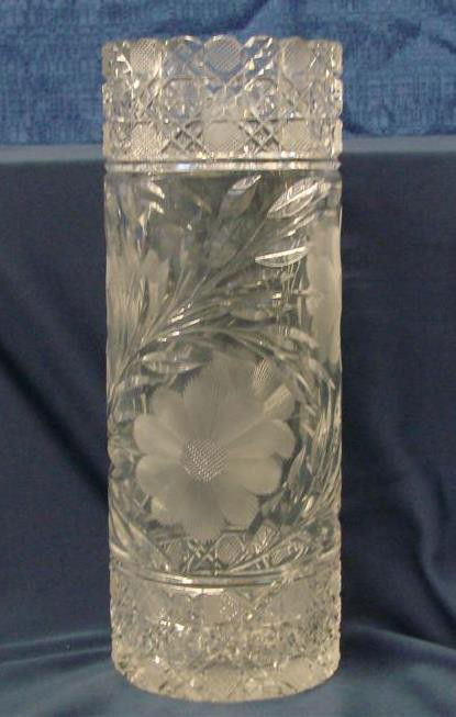Brilliant Period Cut Glass 10" Cylinder Vase: Brilliant Period Cut Glass 10” Cylinder Vase; Lovely Cut Design has Daisy & Button on Top and Bottom with Sunflower Design in Center of Vase. 10" h x 4" dia. Auction Estimate: $100-200.