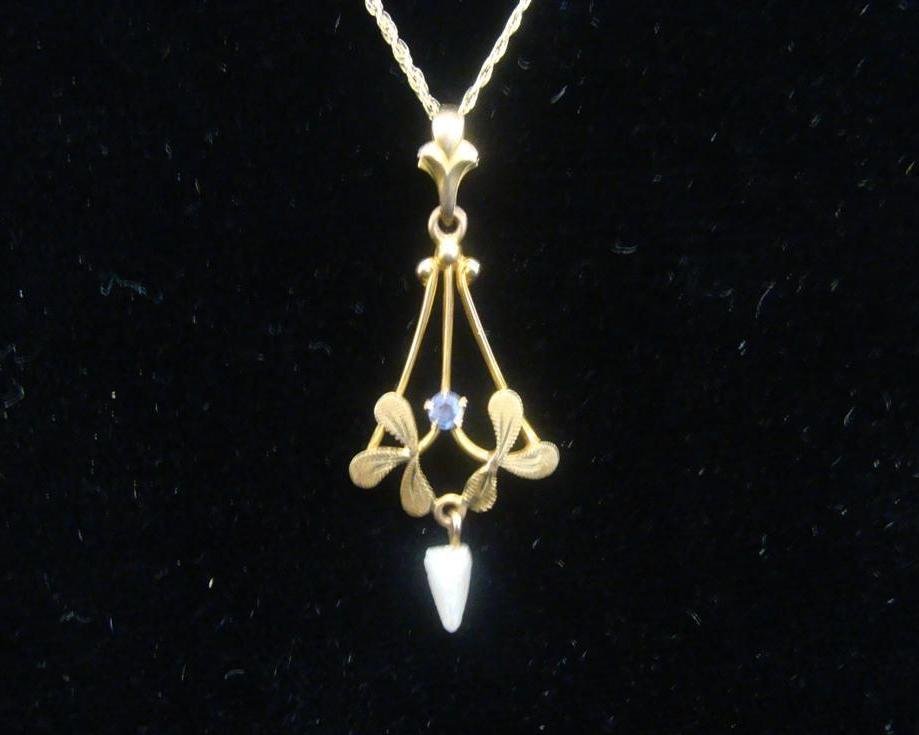 Antique 10K Yellow Gold Lavalier on 18” 10K YG Nec: Antique 10K Solid Yellow Gold Lavalier with a Blue Stone and a Baroque Pearl Drop at Bottom on a 10K solid Yellow Gold 18" Necklace Chain. 1.3 Grams. Auction Estimate $100-200.