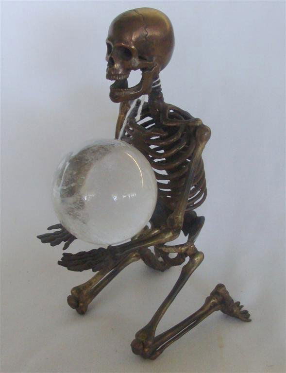 DW Dempsey Bronze Sculpture of Skeleton w Crystal: Rare Bronze Sculpture by David W Dempsey of a Kneeling Skeleton Holding a Crystal Ball. 8.25" Ht x 3.75" Wd. Signed with Etched Signature DWD on Pelvis Bone. Auction Estimate $200-300.