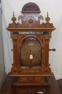 19c German Coin Operated Symphonion Disc Music Box: 19th Century German Walnut Coin Operated Disc Music Box; Hand Painted Stencil at Top of Door Reads "Symphonion Musik-Automat" Carved Eastlake Scrolled Pediment with Double Finial, Comes with Extra Dis