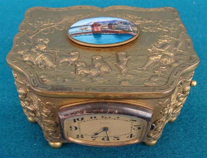 Embossed Brass Automaton Music Box with Singing Bird; E: Embossed Brass Automaton Music Box with Singing Bird; Embossed with Courtesan Scene Cherubs, Birds & Foliage. 8 Day Clock on Front Side, Enameled lid, Bird in Working Condition But Doesn't Chirp. Auct