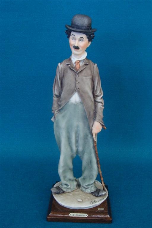 Giuseppe Armani Figurine: Charlie Chaplin #3219C. 1980': Giuseppe Armani Figurine: Charlie Chaplin #3219C. 1980's Version, Depicts Chaplin with his Cane & a Hand in his Pocket. COA included. Auction Estimate: $150-250.