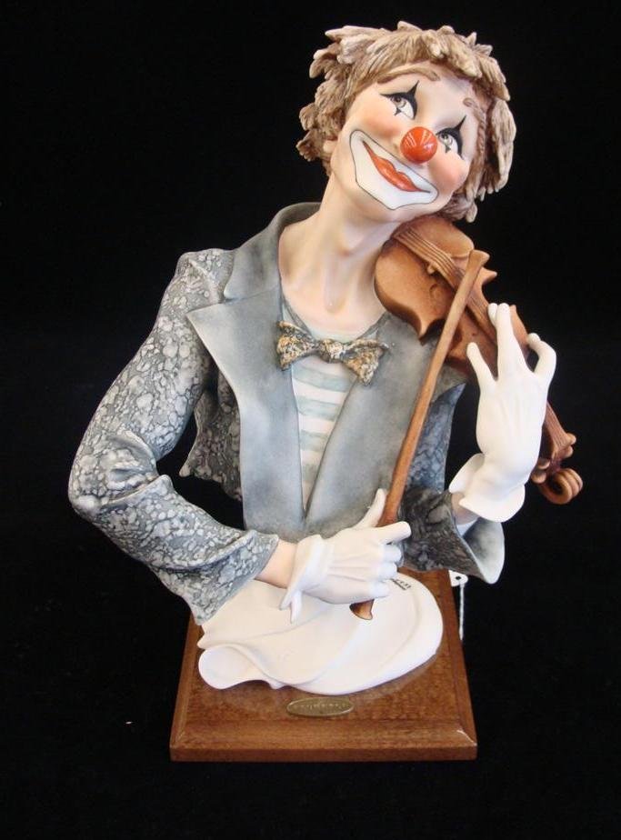 Giuseppe Armani Figurine: The Fiddler Clown; #725E. Ltd: Giuseppe Armani Figurine: The Fiddler Clown; #725E. Ltd Ed #1137/5000; Original Box & COA. Depicts Bust of Clown Wearing Gloves & Playing Fiddle in a Striped Shirt, Tux & Tie. 12.25" Ht. Auction Estim