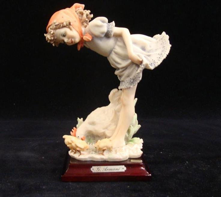 Giuseppe Armani Figurine: Be Good Chicks #1143P. Depict: Giuseppe Armani Figurine: Be Good Chicks #1143P. Depicts Young Girl Bending Over to Talk to her Chick, Her Bottom is Exposed. Auction Estimate: $100-200.