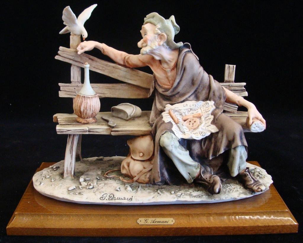 Giuseppe Armani Figurine: Old Man & a Bird #3218C. Olde: Giuseppe Armani Figurine: Old Man & a Bird #3218C. Older Edition. Depicts the Same Old Man as Previous Lots (Richard) Eating Lunch on a Bench Feeding a Bird. Auction Estimate: $250-350.