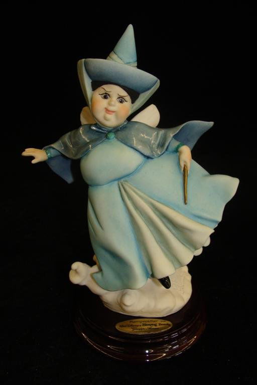 Giuseppe Armani Figurine: Merryweather #607C. Artist Si: Giuseppe Armani Figurine: Merryweather #607C. Artist Signed Fabrizio Tani. Depicts Fairy Merryweather from Sleeping Beauty, She Wears the Blue Dress. Box & COA. Auction Estimate: $75-100.