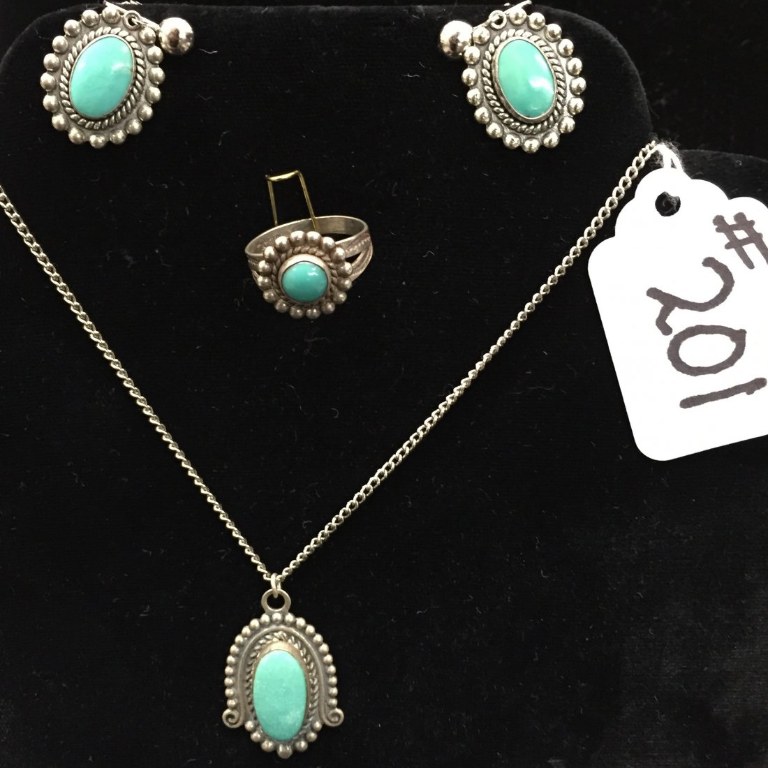 4pcs of Sterling Silver Native American Jewelry.: 4pcs of Sterling Silver & Turquoise Native American Jewelry; Includes a Pendant on a 17" Chain, Pair of Screwback Earrings, and Size 7 Ring. Auction Estimate: $50-100.