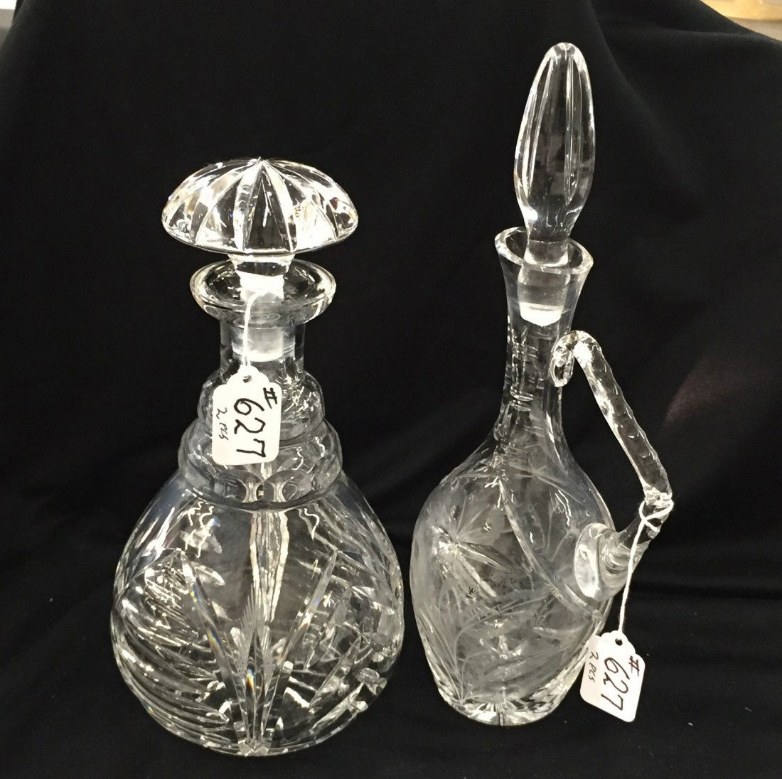 Two Cut Crystal Decanters; One with Intaglio Cut: Two Cut Crystal Decanters; One with Intaglio Cut Flowers & Vines; the Other with Saw Grass. Auction Estimate: $50- 100.