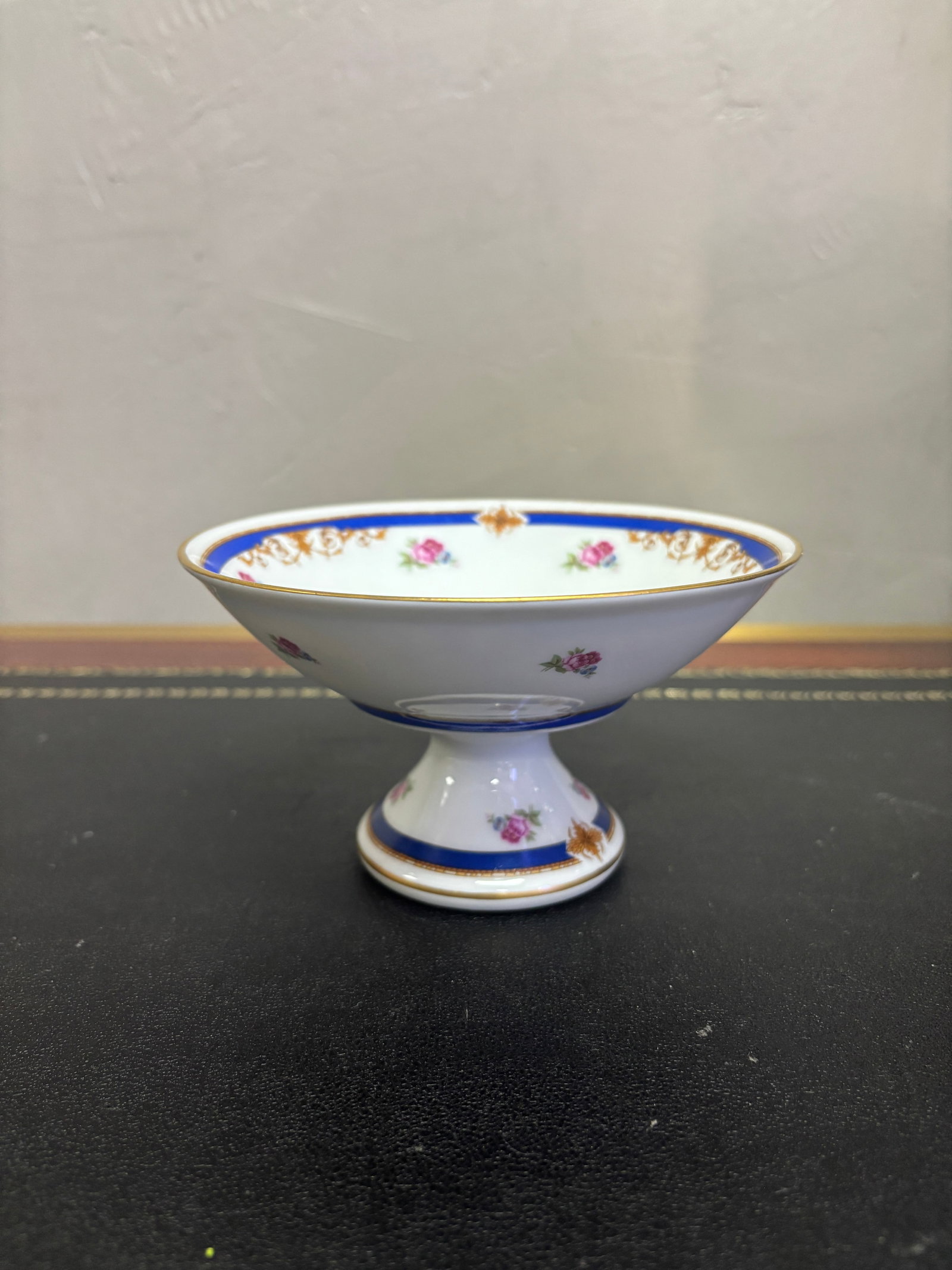 Vintage Limoges Compote: Vintage Limoges French porcelain footed compote or candy dish. This Limoges dish is a little over 3" and 6" across it's flared pedestal base the dish is hand painted gold rim with gold accents. Made i