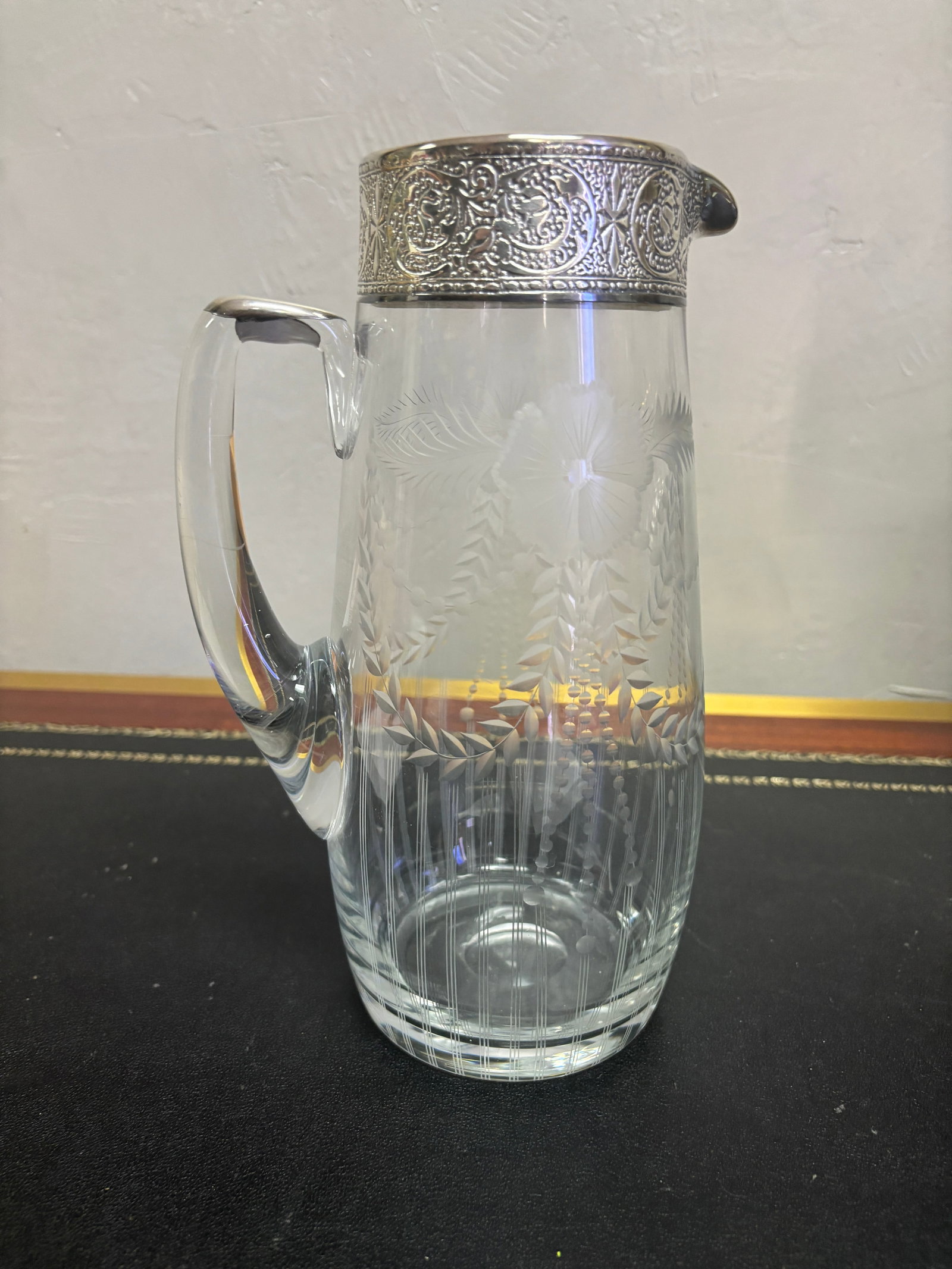 Vintage Cut Crystal Pitcher: Vintage Edwardian crystal water pitcher featuring delicate wheel cut floral and ribbon swags, vertical fluting silver plated rim spout crystal handle. Great addition for your table or bar. 10" tall