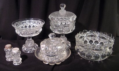 Collection of early "Eye Winker" pressed glass: Collection of early "Eye Winker" pressed glass: round bowl, lidded butler, pedestal compote, lidded candy and pair salts.