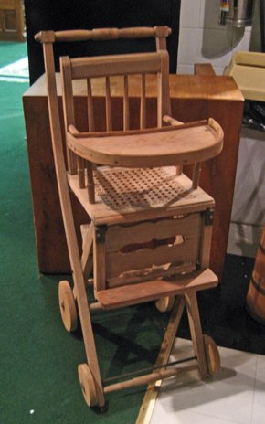 Unfinished walnut child's high chair with caned: Unfinished walnut child's high chair with caned seat, 40" high.