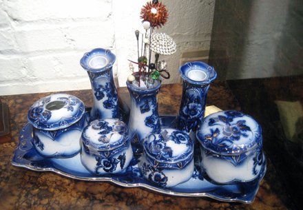 Flow blue porcelain dresser set, "Pansy" patter: Flow blue porcelain dresser set, "Pansy" pattern: dresser tray, pair candlesticks, hair pin holder with hair pins and four lidded dresser jars.
