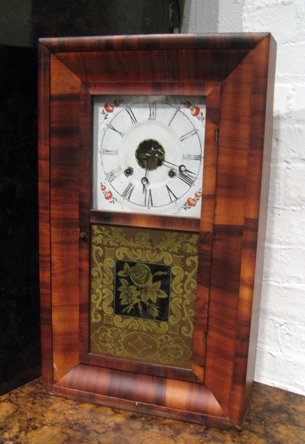Ansonia rosewood cased shelf clock: Ansonia rosewood cased shelf clock with painted dial and reverse painted glass door, time and strike, 25-1/2" high, 15" wide.