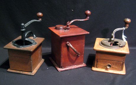 Three early wooden coffee grinders with cast iron: Three early wooden coffee grinders with cast iron mechanics.