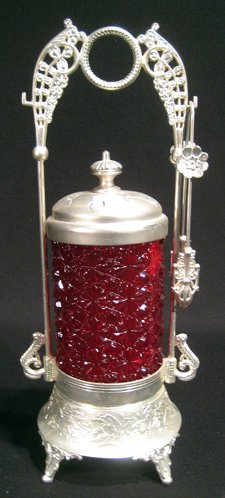 Antique Red Glass Pickle Caster, "Buttons and Bows" : Antique red glass pickle caster, "Buttons and Bows" pattern, in silver metal stand with tongs, 13" high.