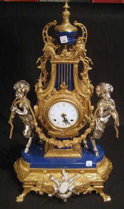 Ornate Imperial Gilded Garniture Clock & 2 Candelabra: Very ornate Imperial gilded metal garniture set: clock with urn finial, fauns standing at each side, time and strike, measuring 24" high, 14" wide and pair matching six-branch candelabra, measuring 27
