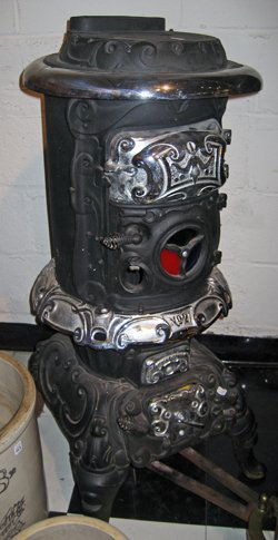 C. Emrich Columbus Ohio Cast Iron w/Chrome Wood Stove: C. Emrich Columbus Ohio black painted w/chrome trim cast iron wood burning stove, 39" high, 17" wide - approx. 50-70 years old.