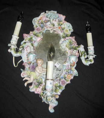 Capodimonte wall mirror with electrified candlest: Capodimonte wall mirror with electrified candlesticks decorated with applied flowers, 19" high, 11" wide. - Antique