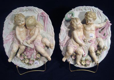 Pair Modern Capodimonte Wall Plaques w/Children: Pair modern Capodimonte wall plaques decorated with young boys, 12" x 9" overall - one damaged at hand.