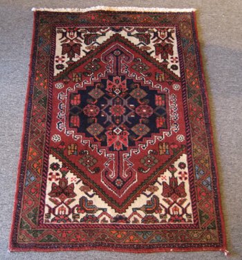 Persian Hamedan: Persian Hamedan ORIGIN: Iran MATERIAL(S): Wool COLORS: navy blue, red, and others DETAILS: hand-knotted SIZE/DIMENSIONS: 3'2" x 4'7"