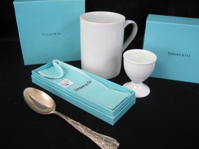 Three Tiffany & Co. items: spoon, mug & egg coddler: Three Tiffany & Co. items: sterling silver collector's spoon from New York, egg coddler and coffee mug - all in original boxes.
