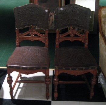 Pair walnut Victorian chairs with carved rail: Pair walnut Victorian chairs with carved mid support rail, leather covered seat and back with ornate design.