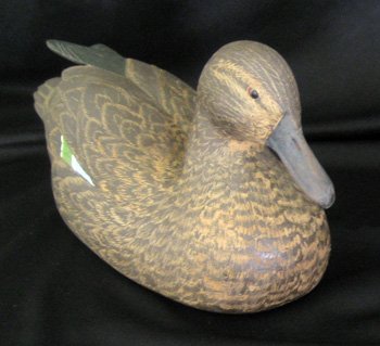 Two hand carved wooden duck decoys: Two hand carved wooden duck decoys with carved and painted feathers, both 10" long - one signed DJS.