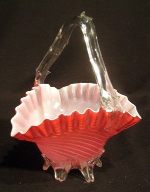 Stevens and Williams red to white swirl glass basket: Stevens and Williams red to white swirl glass basket with ruffled rim and thorn handle, 7-1/2" high.