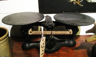 Cast iron balance scale: Cast iron balance scale, 7-1/2" high, 20" wide.