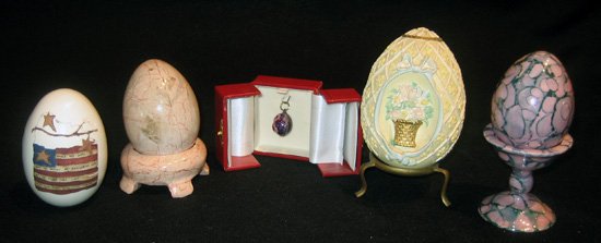 Nine miscellaneous decorated eggs: Nine miscellaneous decorated eggs: two carved stone, six porcelain and one composition from 2" to 4" high.