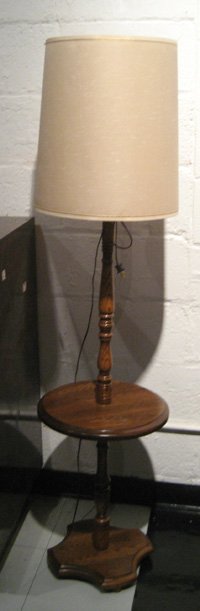 Oak framed floor/table lamp with round central shelf: Oak framed floor/table lamp with round central shelf and card shade, 60-1/2" high.