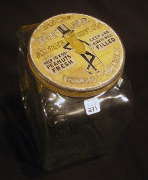 Planters peanuts glass store jar with tin lid: Planters peanuts glass store jar with tin lid, 9-1/2" high.