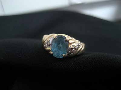 Ladies 14Kt yellow gold Blue Topaz and Diamond ring: Ladies 14Kt yellow gold Blue Topaz and Diamond dinner ring set with one 6x8 oval Blue Topaz with four .03 ct round brilliant cut diamonds AGE: MARKINGS: CONDITION: SIZE: 3 1/2