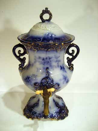 Antique Wheeling Pottery Flow Blue Urn, Brass Spigot: Wheeling Pottery flow blue coffee urn with brass spigot, marked patent Jan 25 1853 AGE: Antique CONDITION: lid damaged SIZE: 16" high