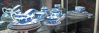 24 Pcs of Miscellaneous "Blue Willow" porcelain: Collection of miscellaneous "Blue Willow" porcelain: three dinner plates, five luncheon plates, three bread plates, two soup bowls, two cups, four rice bowls, two saucers, lidded sugar, gravy boat and