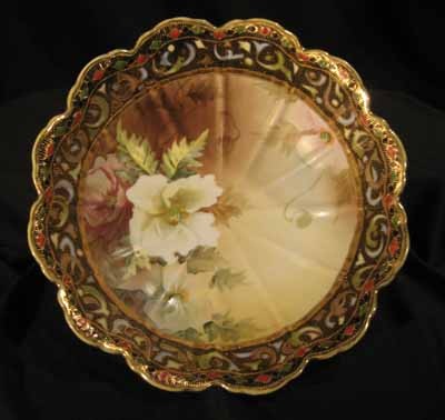 Hand painted Nippon Porcelain Footed Bowl: Hand painted Nippon porcelain footed bowl decorated with white flowers. 4" high x 11.25" diameter.