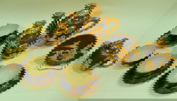 Japanese Earthenware Tea Set: Japanese earthenware tea set decorated with figures and dragon finials: teapot, 4 cups, 4 saucers, lidded sugar and lidded creamer.