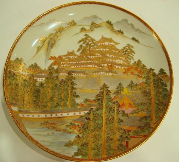 Signed Hand Painted Porcelain Charger: Hand painted porcelain charger decorated with Chinese village, signed on verso Kutani, 12" diameter.